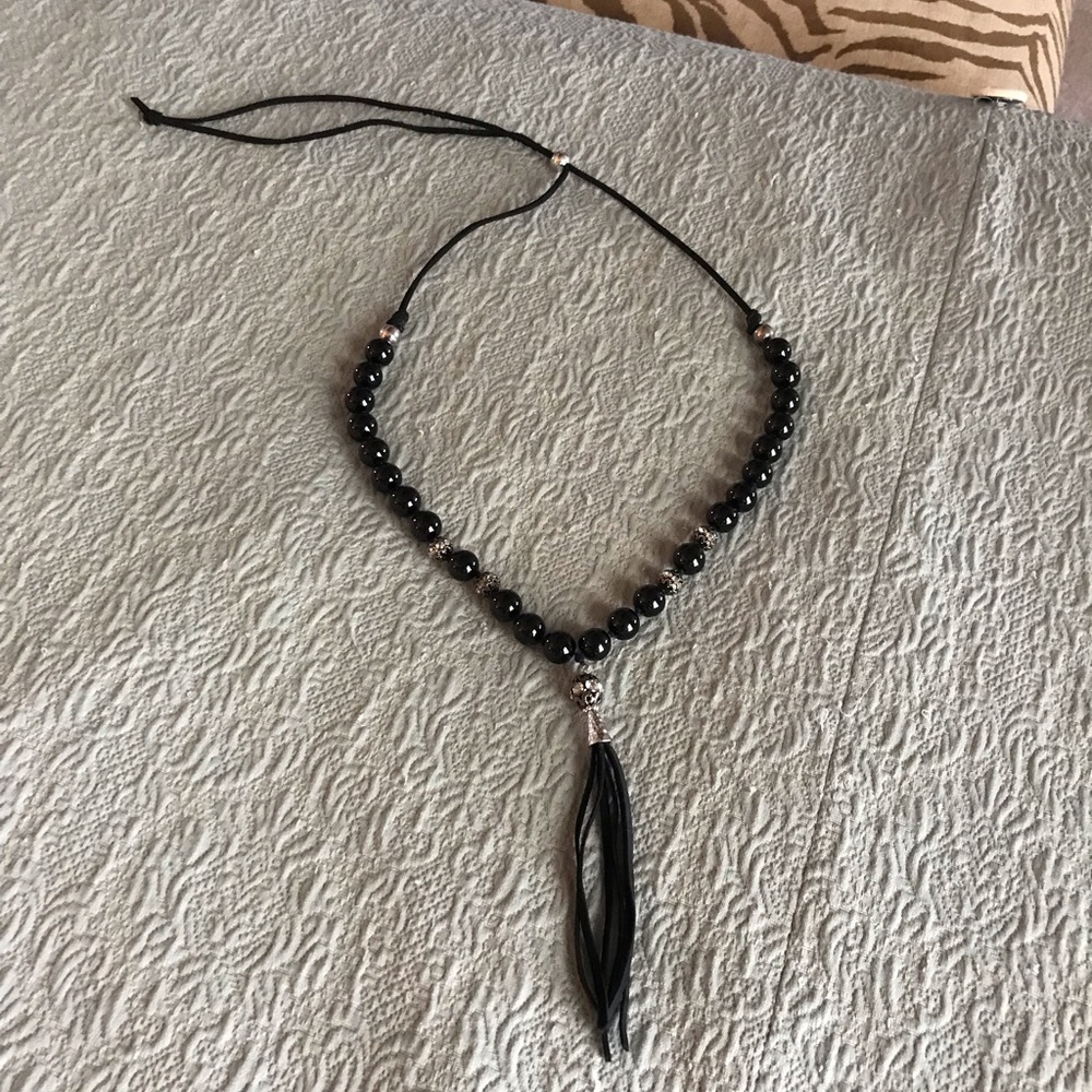 Black beaded necklace with leather tassel